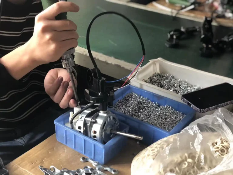 Electric fan motor assembly for pedestal fan production
