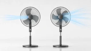 Side-by-side comparison of two matching black pedestal fans in a clean studio, with exactly three blades on the left and five blades on the right. Pale blue airflow streams illustrate the focused breeze of the 3-blade fan and the wider, smoother airflow of the 5-blade fan.