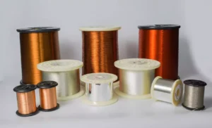A collection of various spools containing reddish-brown copper wire and silver-colored aluminum wire arranged on a white background.