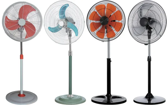 A showcase of diverse industrial pedestal fan models designed for commercial cooling. The lineup displays a variety of aesthetic and functional options, including fans with vibrant red, teal, and orange plastic blades, as well as a model with durable silver blades. Each unit features a robust round base and protective wire grills, demonstrating the customization available for wholesale or export markets.