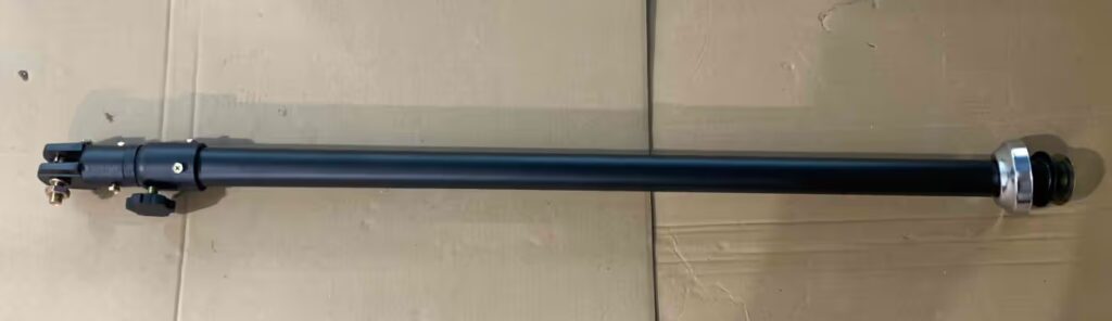 A sturdy replacement telescopic rod designed for standing pedestal fans. This matte black metal pole includes a secure locking knob for height adjustment and a chrome-plated bottom flange, ensuring stable support and flexible positioning for cooling airflow.